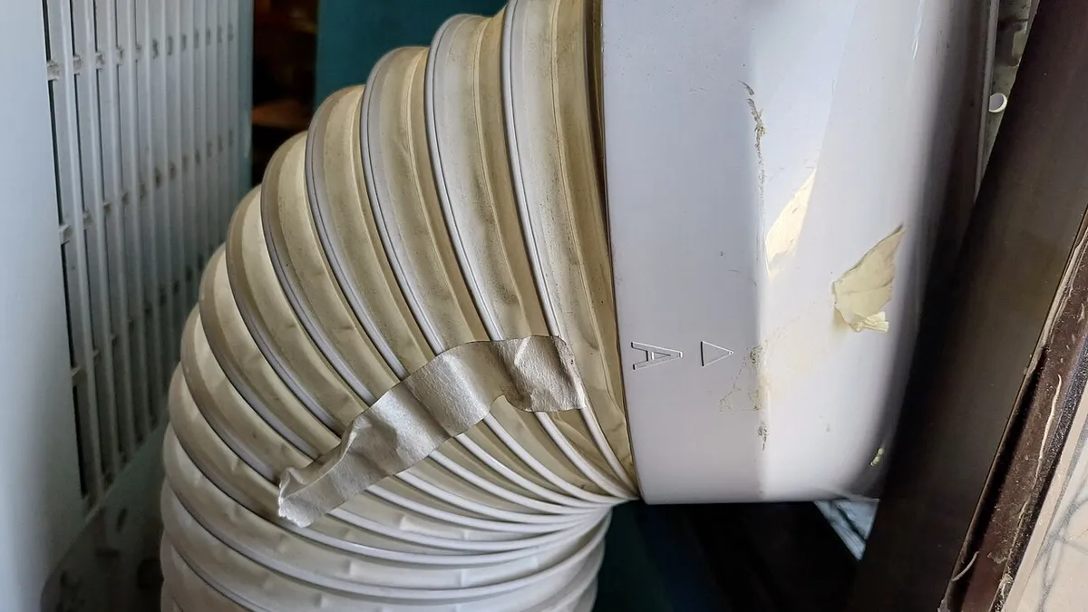 Exhaust hose of a portable air conditioner fitted to a window